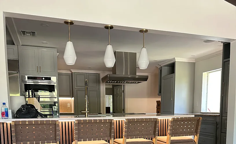 Glass pendant lights installed over a kitchen island