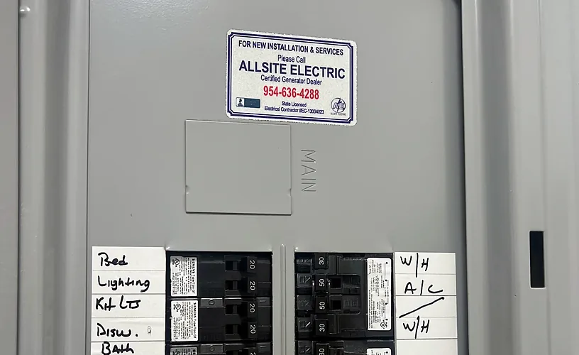 New electrical panel with handwritten circuit labels and an Allsite Electric service sticker
