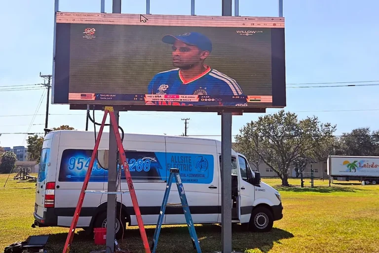 Allsite Electric van parked under an outdoor sports park video board during a power upgrade